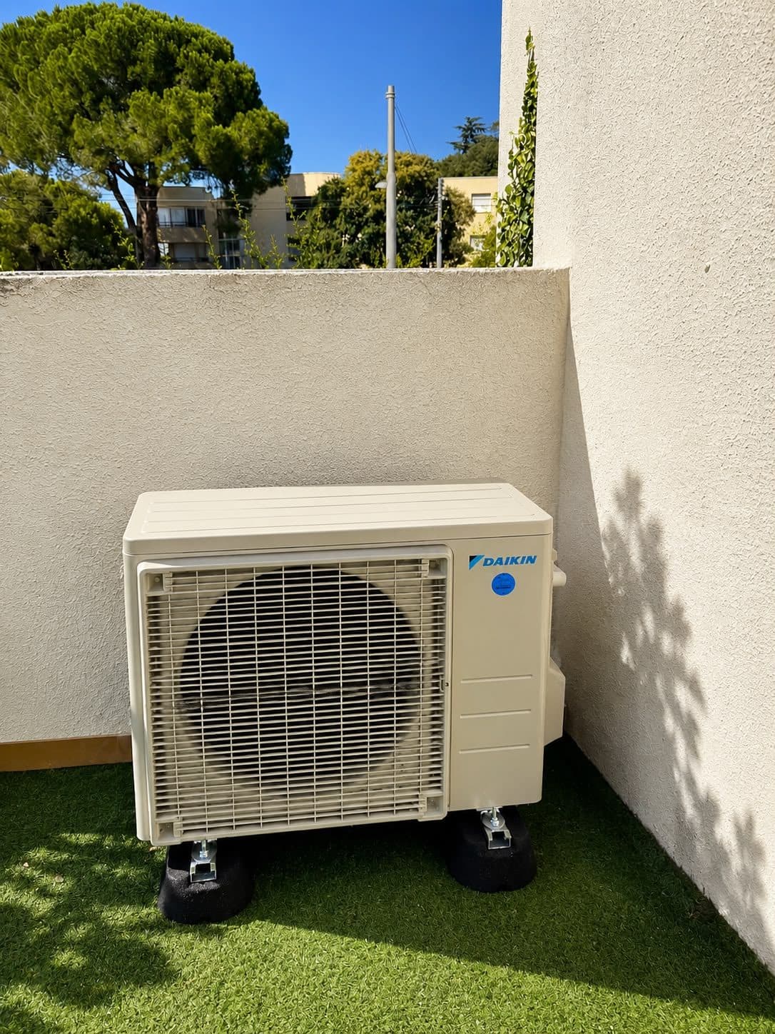 Groupe extérieur de climatisation Daikin posé sur plots antivibratiles en terrasse d’appartement